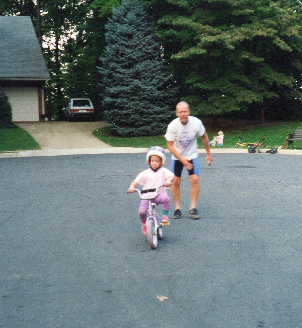 Bruce watching on as Julie rides a bicycle for the first time